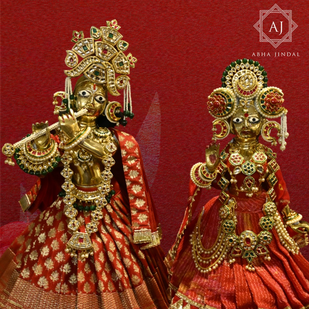 Radha and Krishna dressed in a red South Indian-inspired shringar presentation.